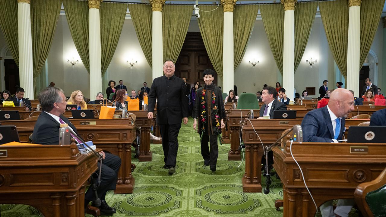 Asm Ting and Annie Chung walking down the isle in the assembly chambers